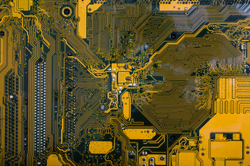 Yellow electronic circuit board close up.