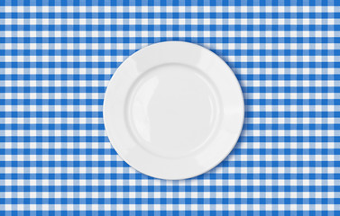 table with blue picnic cloth and plate top view