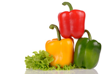 Yellow Green and Red peppers on salad leaf isolated on white bac