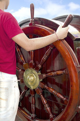 man at the helm of ship