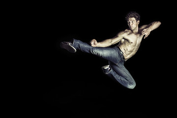 Martial art athlete doing the kick jumping