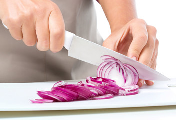 Cook is chopping onion