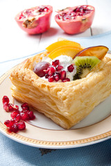 Delicious puff pastry with cream and fruits
