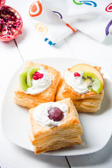 Delicious puff pastry with cream and fruits