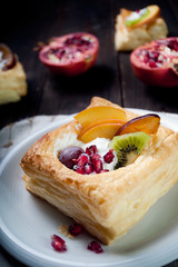 Delicious puff pastry with cream and fruits