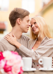 romantic happy couple kissing in the cafe