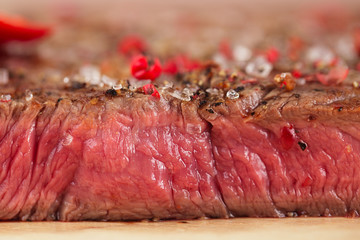 Beef steak on a wooden board and table