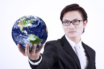 Businessman giving globe - isolated