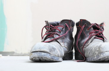  pair of old dirty work boots in building site