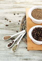 Assortment of spices in  white spoons and bowls,