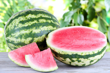 Ripe watermelons on wooden table on nature background © Africa Studio