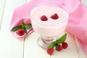 Delicious yogurt with berries on table close-up