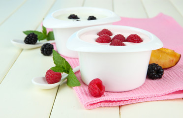 Delicious yogurt with fruit and berries on table close-up