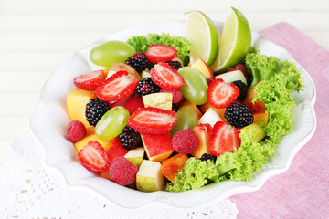 Fruit salad in plate on napkin  wooden table