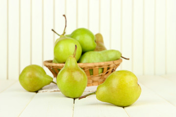 Pears in  wicker basket, on light background