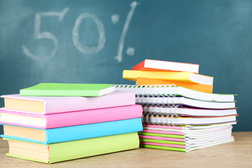 Office supplies on table on school board background