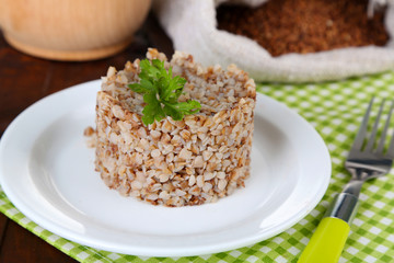 Buckwheat in plate and cloth bag closeup