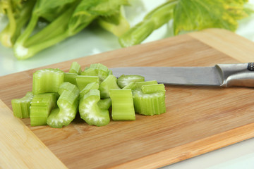 Fresh green celery on cutting board close-up