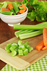 Fresh green celery with vegetables on table close-up