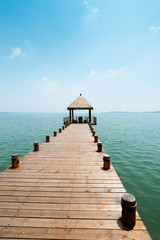 Fototapeta premium Wooden jetty over the beautiful Maldivian sea with blue sky