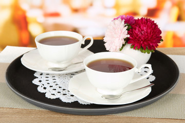 Cups of tea on tray on table in cafe
