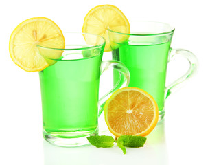 Two transparent cups of green tea with mint and lemon isolated
