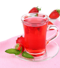 Delicious strawberry tea on table on white background