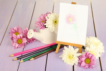 Composition of flowers and  small easel with picture