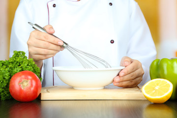 Cook hands whisking mayonnaise