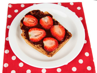 Delicious toast with strawberry on plate close-up