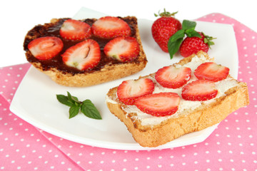 Delicious toast with strawberry on plate close-up