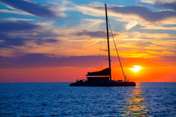 Ibiza san Antonio Abad catamaran sailboat sunset - obrazy, fototapety, plakaty