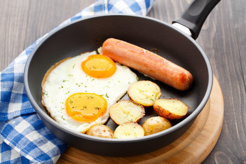 Breakfast with eggs, sausage and potato
