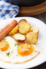 Breakfast with eggs, sausage and potato