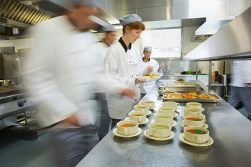 Four chefs working in a modern kitchen