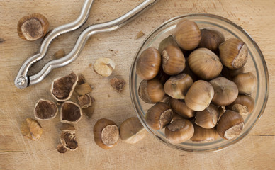 Hazelnuts with nutcracker on the wooden board