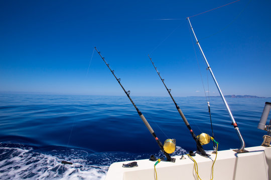 Fototapeta Ibiza fishing boat trolling rods and reels in blue sea
