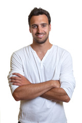 Fototapeta premium Standing latin man in a white shirt
