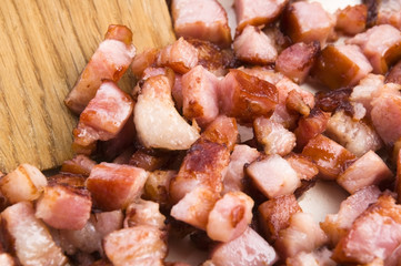 Macro photo of bacon being fried in a pan
