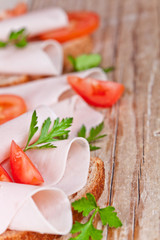 bread with sliced ham, fresh tomatoes and parsley