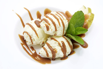 ice cream with caramel sauce and mint on a white background