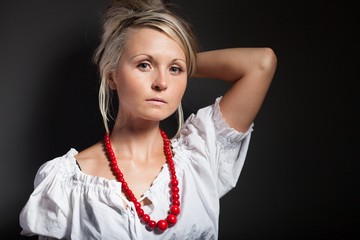 Folk woman in folklore clothes braiding a plait