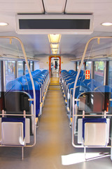 Fototapeta premium Rows of seats in a passenger train car.