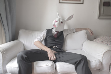 rabbit mask man sitting on sofa