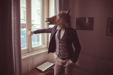 horse mask man in front of window