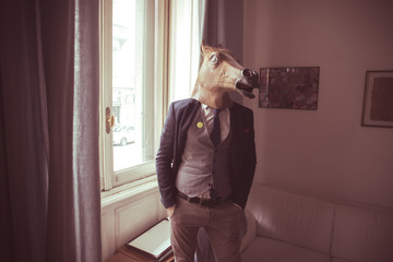 horse mask man in front of window