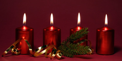 Four burning red candles