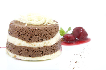 cream dessert garnished with mint on a white background