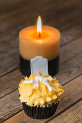 Halloween pumpkin cupcake and a burning candle