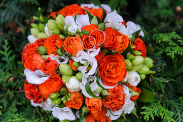 Wedding rings on a bouquet of roses